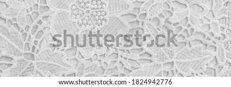 Beautiful white lace cloth, close up. White lace floral pattern textile fashion background. Openwork fabric white lace texture, banner