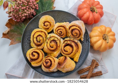 sweet home made autumn cinnamon rolls with pumpkin
