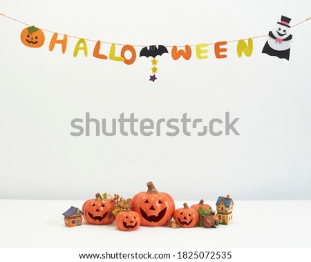 Jack O Lantern  or Pumpkins decor on a white desk at home for happy halloween concept