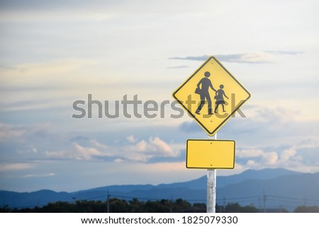 School zone ahead sign isolated on clouds on the sky background.
