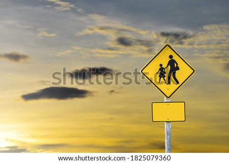School zone ahead sign isolated on clouds on the sky background.