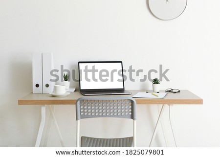 Workplace with modern laptop in the interior of the room