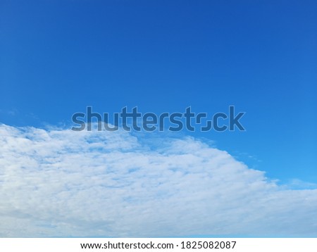 The morning sky with distant white clouds is a picture of the sky over the sea.