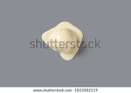 top view vanilla flavor ice cream ball starts melting on grey background