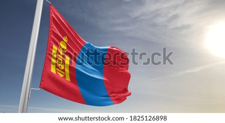 Mongolia national flag cloth fabric waving on beautiful sky.