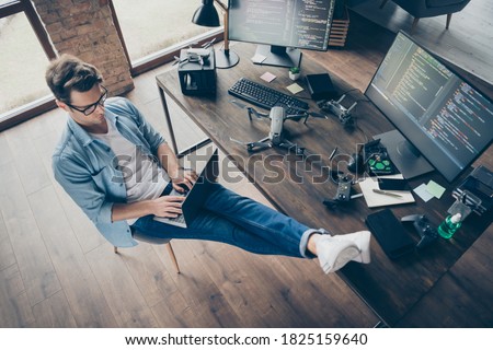 Top above high angle view of his he nice attractive focused skilled guy geek typing coding web development remote support security safety at modern loft industrial home office work place station Royalty-Free Stock Photo #1825159640