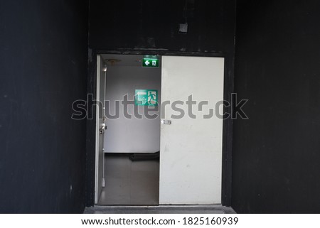 Scenery background of the exit way with opened door (Thai wording is exit)