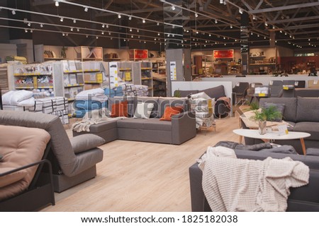 Furniture store with sofas and couches on display for sale, copy space Royalty-Free Stock Photo #1825182038