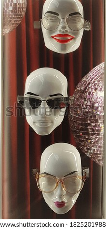 faces of mannequins in optics with glasses and sunglasses. The concept of an optician's store. Close-up mobile photo