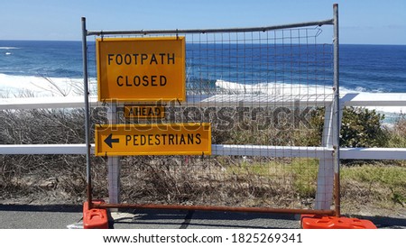 Selective focus view of Signboard about pedestrian footpath closed signs by the beach. Construction building sign, alert sign. 