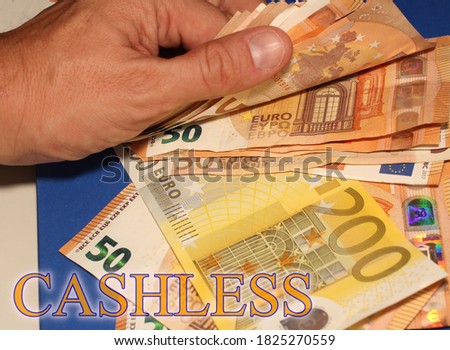 shot of euro money with the sign "cashless"