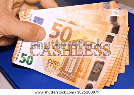 shot of euro money with the sign "cashless"