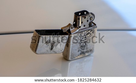 Close up of the old zippo lighter on the table Royalty-Free Stock Photo #1825284632