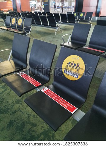 New normal seats at the airport put symbol signages to inform people keep physical social distancing to stop spreading covid-19 for public health safety. Concept safe travels.