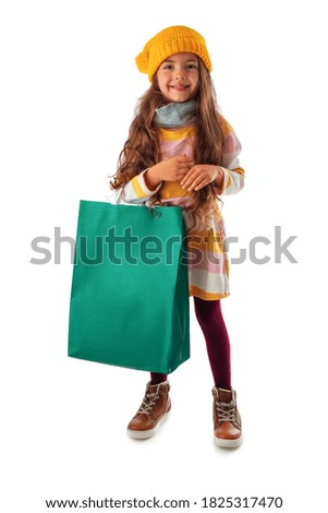 Happy beautiful young girl with shopping bag, portrait on white background