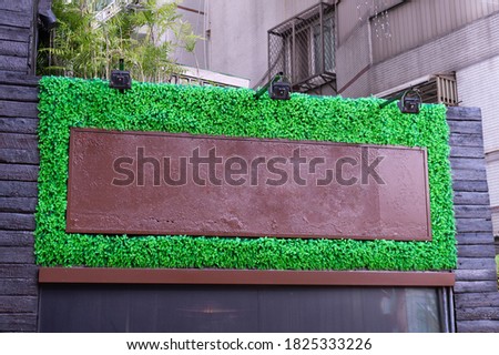 Large blank billboard on a street wall, banners with room to add text