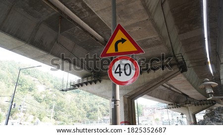 40 km speed limit and traffic sign to beware of curves