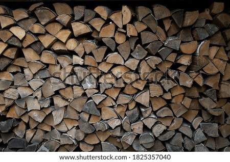 Split birch wood for heating, evenly stacked in rows for storage