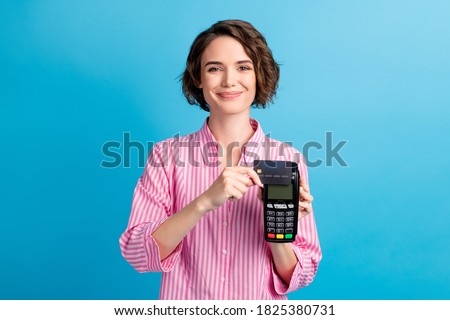 Photo of positive lady swipe credit card on pos terminal wear formal white pink clothes isolated over blue color background