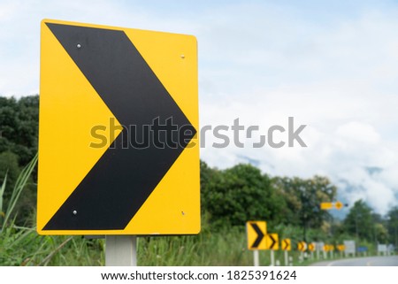 Curve warning sign on the road.