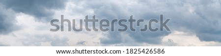 High resolution (54 megapixels) wide format photo of a dramatic overcast sky, with grey clouds. Taken in the afternoon. Freedom, storm, beauty of nature.
 Royalty-Free Stock Photo #1825426586