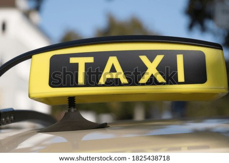 Black and yellow colored taxi sign on the roof of a taxi car in Germany