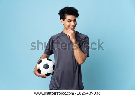Venezuelan football player man over isolated background looking to the side and smiling