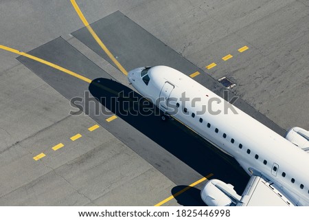 Aerial view of airport. Airplane taxiing to runway before take off.