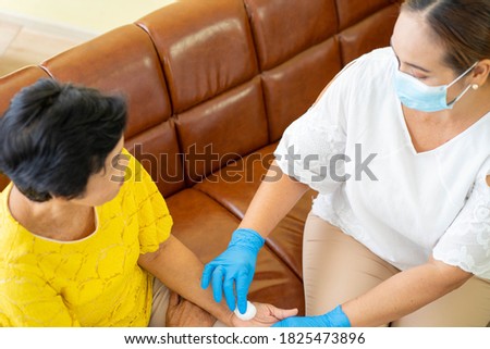 Senior Asian woman  in hospital with daughter taking care with protective face mask.  Health care and medicine concept.
