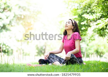 Beautiful woman doing yoga pose meditation and Ballet in the public park, Healthy body posture with happy feeling in the morning. Sport concept.