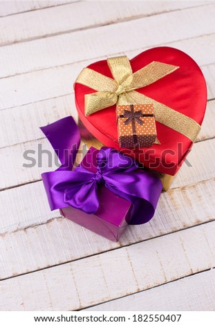 Festive gift boxes on white wooden background.