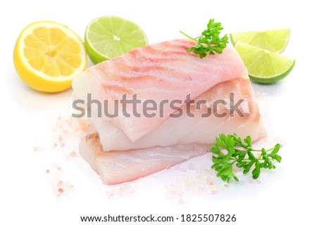 Raw fish with lemon and lime on white background, isolated.