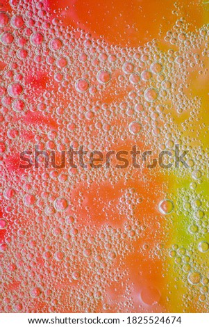 Oil bubbles on colourful background, yellow and orange colors