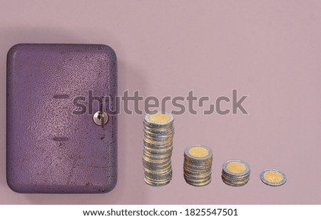 Close up of piggy bank with coins around. Savings concept