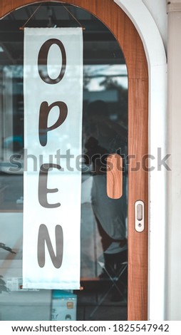 Come in we're open sign, on cafe or restaurant hang on door at entrance. Vintage color tone style.