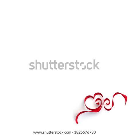 Decorative red bow and ribbons with heart shape on a white background. Holiday, San Valentine decoration. Related to gift. Frame with copy space.