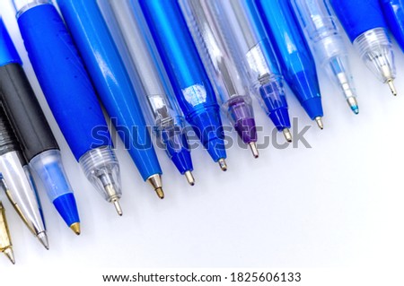 lots of blue ballpoint pens on a white background, multi-colored ballpoint pens Royalty-Free Stock Photo #1825606133