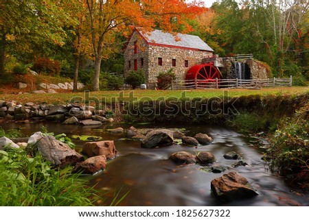 The Wayside Inn Grist Mill with water wheel and cascade water fall in Autumn, Sudbury Massachusetts USA Royalty-Free Stock Photo #1825627322