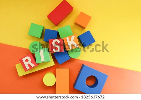 Text on risk on colorful cubes on yellow and orange background 