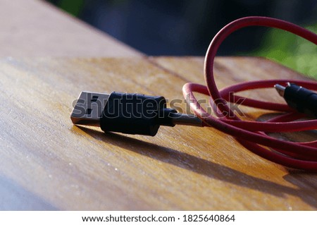 Red USB connection with blur bokeh background.