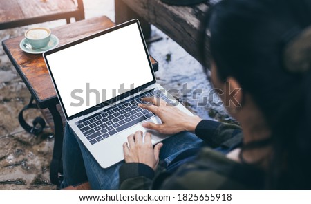 computer mockup blank screen.hand woman work using laptop with white background for advertising,contact business search information on desk at coffee shop.marketing and creative design