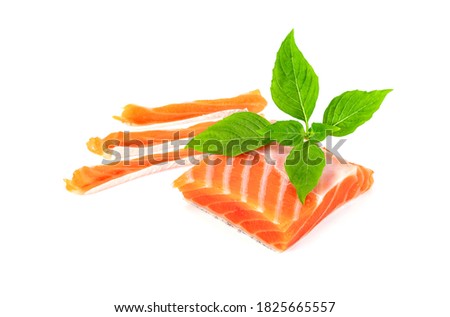 Piece of fresh salmon fillet sliced with leaf basil isolated on white background 