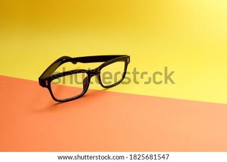 Eyeglasses on yellow and orange background.  Retro style 