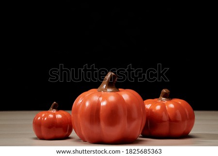 Halloween holiday concept with pumpkin head jack lantern on wooden table with dark background copy space for text