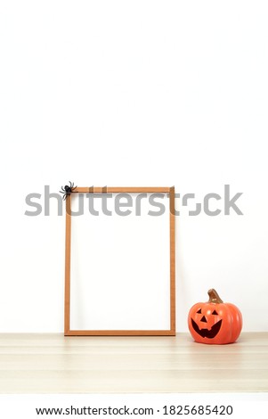 Wooden frame with jack o lantern Lovely on decoration a shelf or desk with white wall with. Halloween concept copy space for text