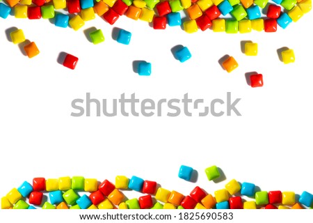 Colorful candy frame on a white background top view frame. Chewing gum, and dragees are scattered