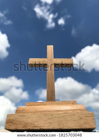 Cross wood with sky background.