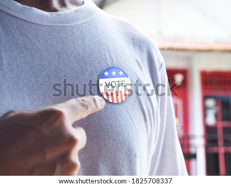 Presidential election 2020 American votes concept. Voting badge pined on T-shirt, close up Royalty-Free Stock Photo #1825708337