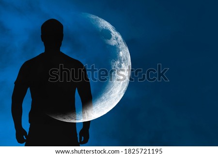 Silhouette of man with transparent crescent or moon on body in front blue sky during night, concept picture about space, astronomy and astrology