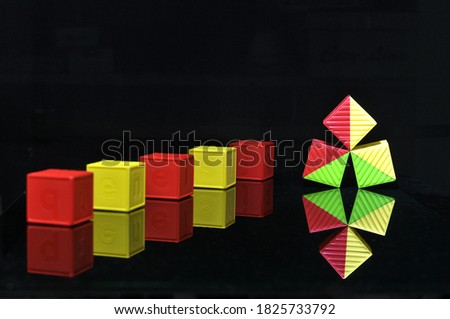 red green yellow box children's toys with bright colors on a black background